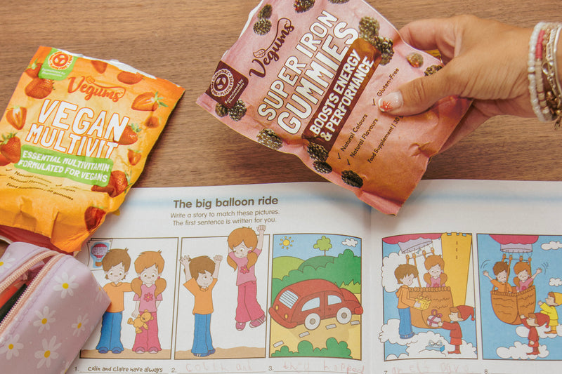VGKIDS05 Child doing an activity book with Vegums kids vitamins