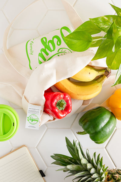vegums tote bag filled with peppers bananas and surrounded by eco items and plants vegan gummy vitamins uk