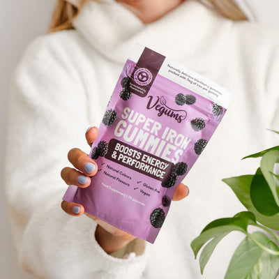 woman holding vegums vegan iron gummy vitamins