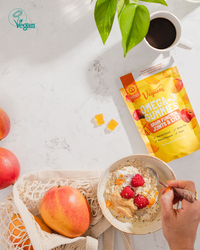 image of vegums fish free omega 3 gummy vitamins with health ceral bowl apples mangoes and cofee cup