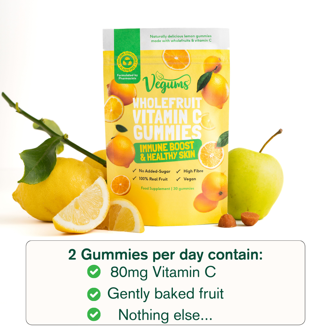 Vegums wholefruit vitamin c packet with fresh fruit surrounding the packet like lemons and apples on white background