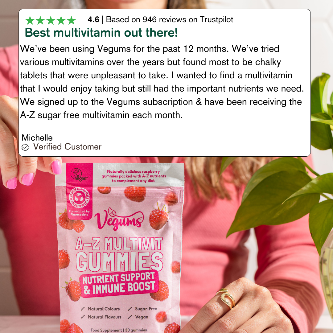 Person holding a package of Vegums A-Z Multivit Gummies with a Trustpilot review overlay.