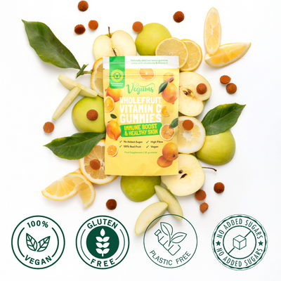 Vegums Whole Fruit Vitamin C Gummies packaging surrounded by fruits and leaves on a white background