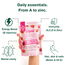 Vegums A-Z Multivit Gummies packaging held by a hand with text highlighting benefits.